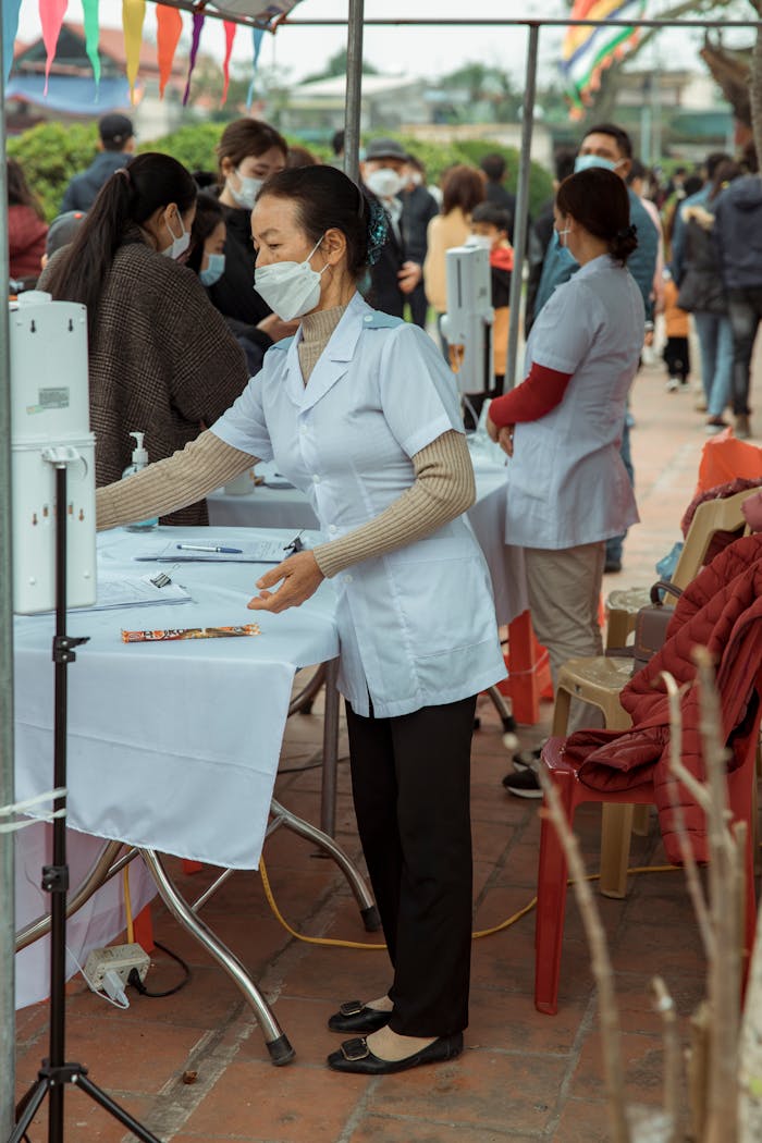services-01 Group of healthcare professionals in masks at an outdoor medical event providing assistance.